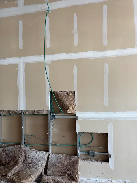Commercial wall wiring with new circuit drops in progress.