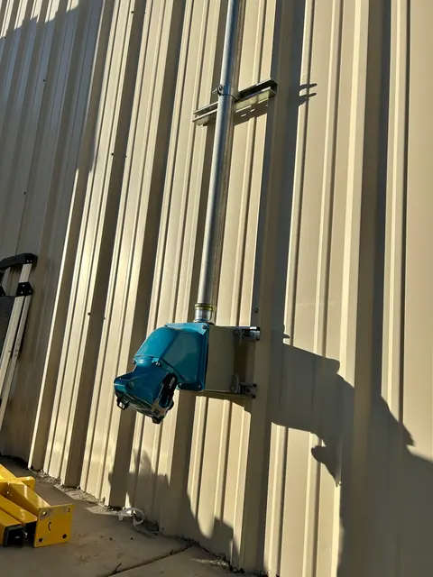 Industrial power connection with surface-mounted conduit.