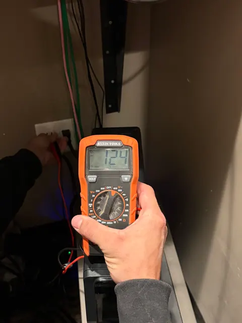 Outlet voltage testing behind equipment.