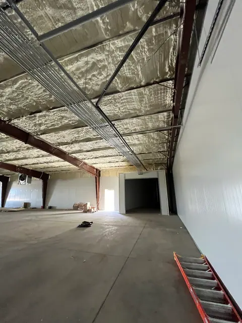 Overhead conduit installation during a commercial build-out.