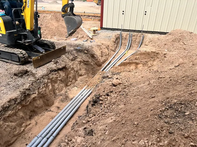Underground electrical conduit installation before backfill.