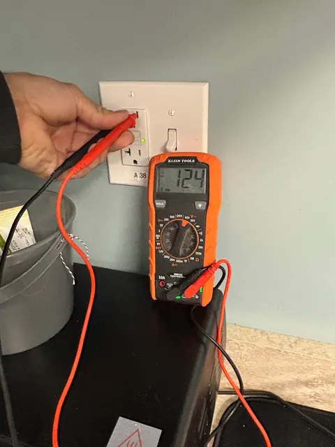 Voltage testing at a GFCI outlet.