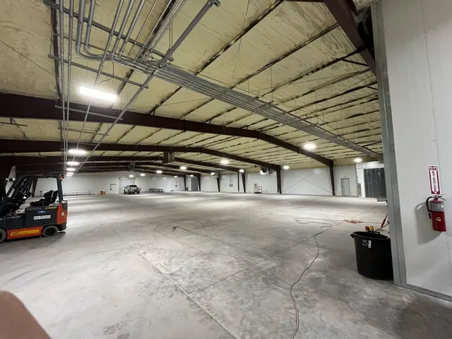 Warehouse lighting and overhead electrical conduit.