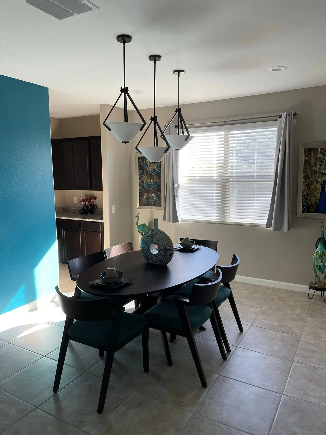 Pendant lights installed over a dining room by Gray Electric